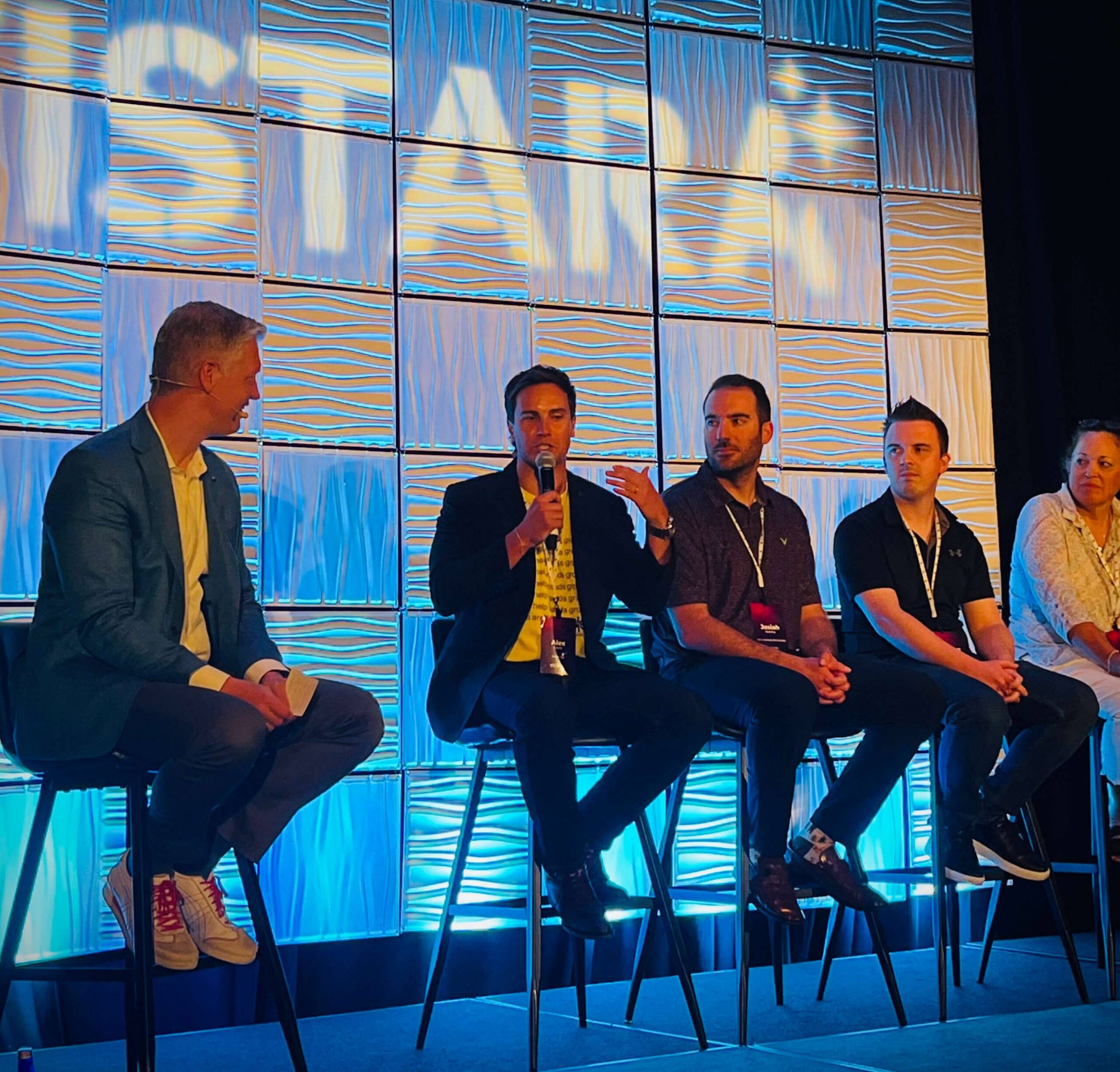 Alex speaking on stage